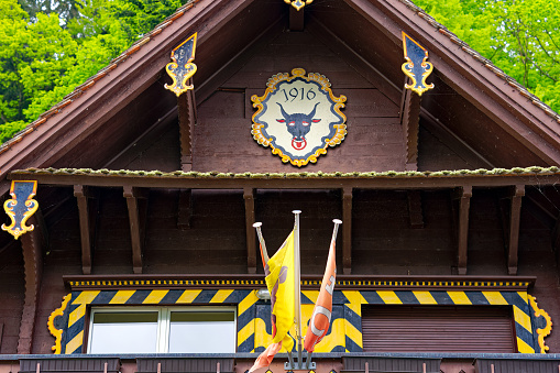 Close up of wooden facade with coat of arms of Canton Uri of station of Seelisberg Treib cable car TSB on a cloudy spring day. Photo taken May 18th, 2023, Treib, Canton Uri, Switzerland.