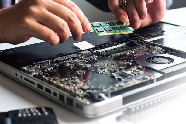 istock Computer repair, notebook repair, use hand to change RAM put ram in notebook machine transmission device 1557556004