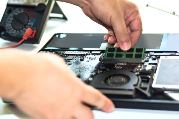 istock Computer repair, notebook repair, use hand to change RAM put ram in notebook machine transmission device 1557556559