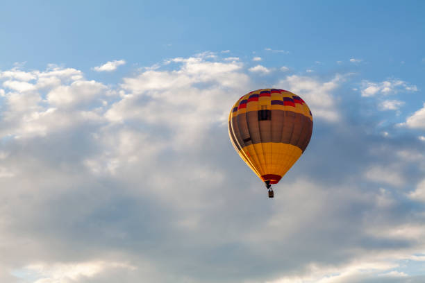 istock A multi-colored balloon flies against the background of a cloudy sky 1557569722