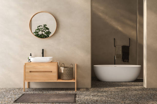 istock Beige bathroom interior with wooden vanity, bathtub, terrazzo floor 1557586286