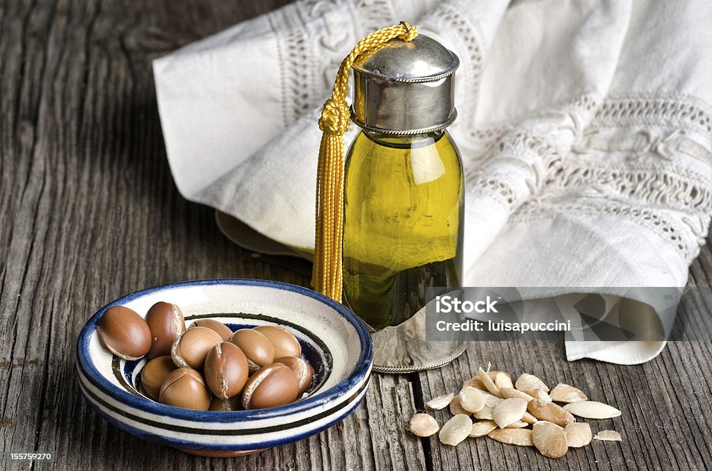 Argan oil and fruit Bottle of argan oil and argan fruit. Argan oil is used for skincare products. Argan Oil Stock Photo