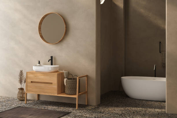 istock Beige bathroom interior with wooden vanity, bathtub, terrazzo floor. 1557607791
