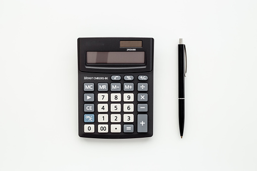 Business accounter working with calculator for taxes accounting.