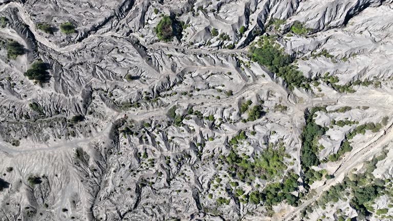 Aerial Drone The surface around the crater of Mount Bromo, Rocks with volcanic rock and sand dune on background on East Java, Java island in Indonesia