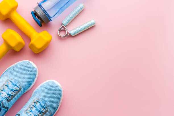 istock Athletics set with sneakers and dumbbells, top view 1557668523