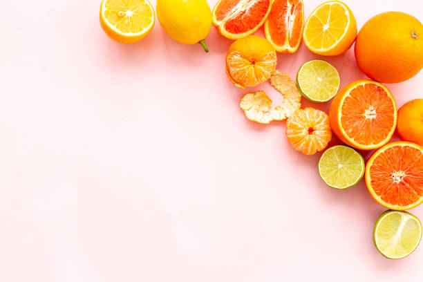 istock Mixed fruits background layout - many citrus slices top view. 1557674066