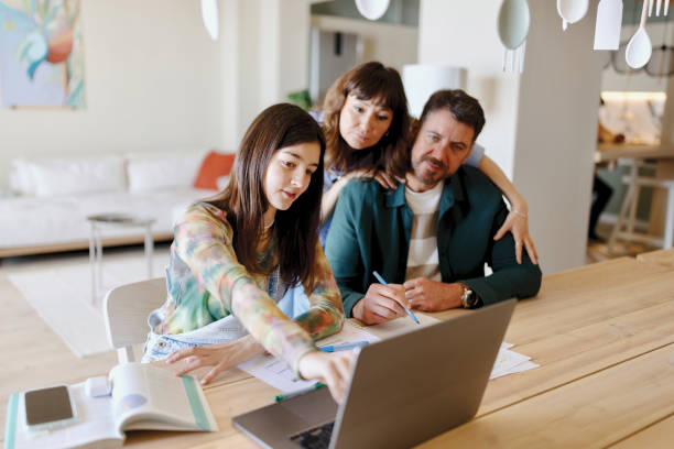 istock Lovely family working on a school project together 1557675753