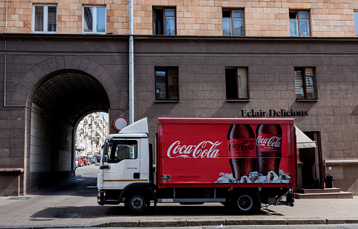 Minsk, Belarus, July 2023 -  Red Coca-Cola delivery truck parked in the street