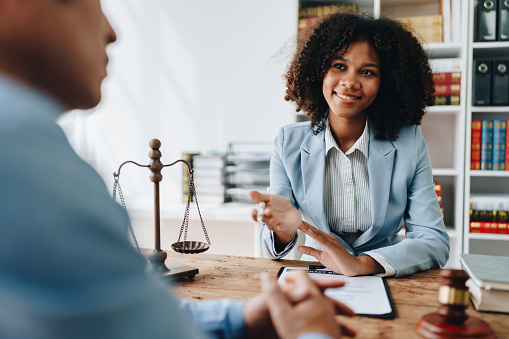 african american attorney, lawyers discussing contract or business agreement at law firm office, Business people making deal document legal, justice advice service concepts.