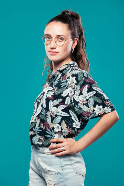 Young girl in summer outfit and eyeglasses at studio