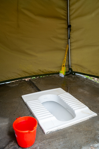 Outdoor toilet tents with Indian squat toilet seats. Camping in Uttarakhand, India.
