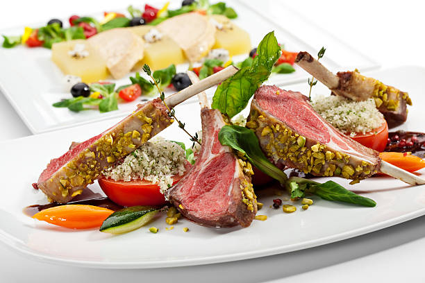 Lamb Chops and Vegetables Roasted Lamb Chops with Pistachio. Garnished with Vegetables and Basil rack of lamb stock pictures, royalty-free photos & images