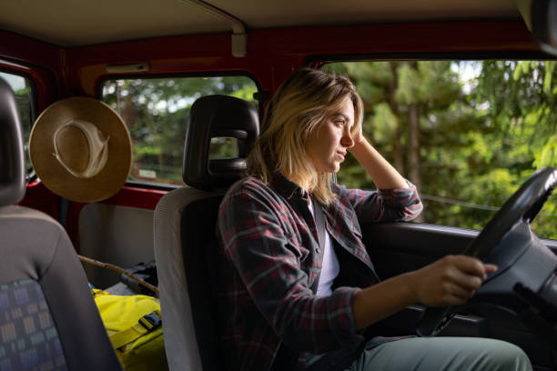 istock Young female tourist going on a trip by car. 1557726759