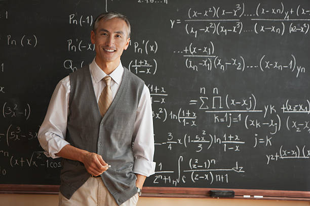Portrait of teacher with in front of blackboard New Jersey math teacher stock pictures, royalty-free photos & images