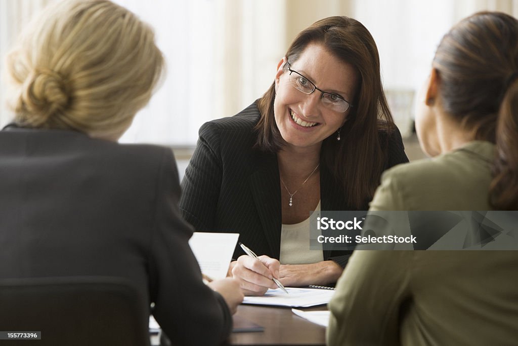 Businesswoman in discussion with colleagues New Jersey 40-44 Years Stock Photo