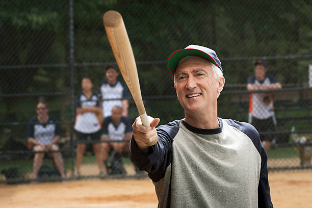 Senior man holding baseball bat New York City old baseball stock pictures, royalty-free photos & images