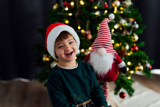istock Happy child with Santa Claus hat laughing 1557752535