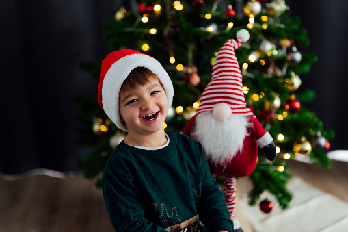 Happy child with Santa Claus hat laughing