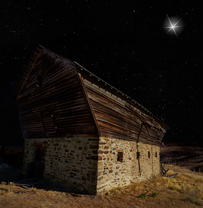 Crumbling barn on Christmas Eve with a star shining brightly above