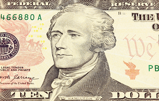 Macro photograph of a ten dollar bill, $10. Selective focus to the eyes.