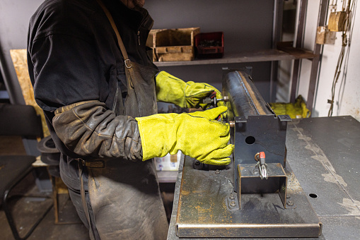 Focused welder using a tightening tool on metal.