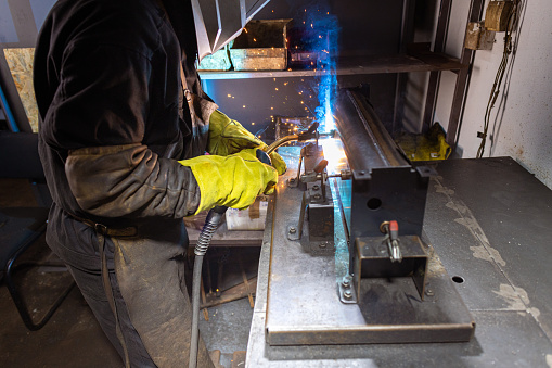 A mesmerizing sight of metal fusion, as the welder uses a torch in his workshop.