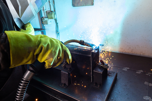 A portrait of a welder at the torch, bringing metal to life in his workshop.