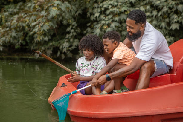 istock Father and Sons having pedal boat fun on the water 1557778252