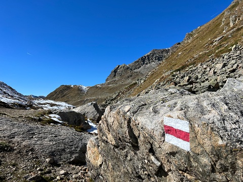 Alpine mountaineering signposts and markings in the mountainous area of the Albula Alps and above the Swiss mountain road pass Fluela (Flüelapass), Zernez - Canton of Grisons, Switzerland (Schweiz)