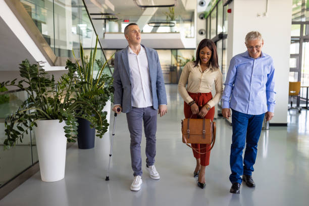 istock Business people walking in a hallway together 1557793807