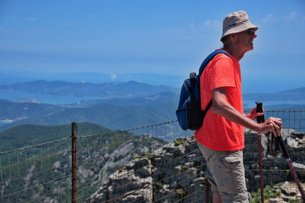 istock Senior man hiking in mountains 1557803389