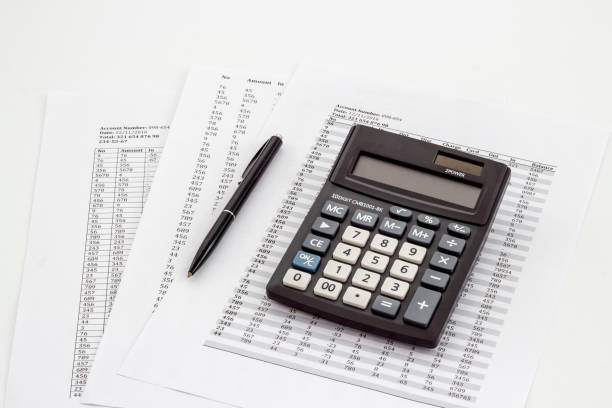 istock Financial business report preparing with calculator on office table 1557811915
