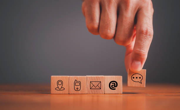 istock Website page contact us or e-mail marketing concept, Customer support hotline Contact us people connection. Cube wood with the email, call phone, address, Chat message and location icons. 1557817253