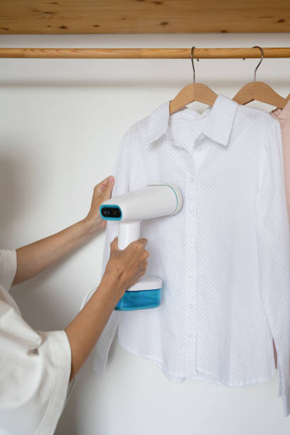 istock An unrecognizable woman steams a shirt 1557861944