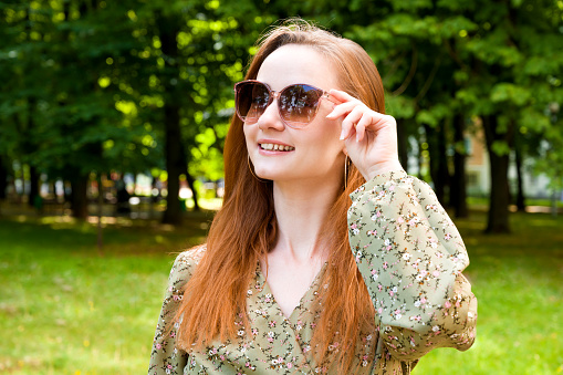 young beautiful girl in sunglasses in Park in spring