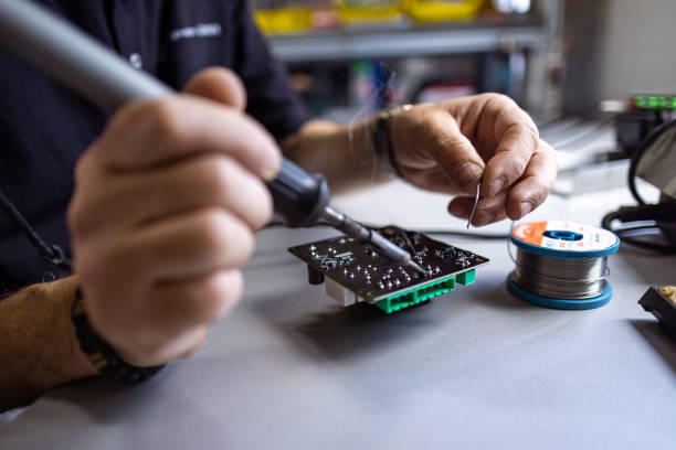 A close-up shot features a focused man using a soldering iron to repair a device, displaying his soldering skills.