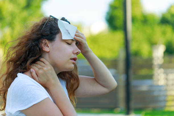 istock Young woman having hot flash and sweating in a warm summer day 1557892421