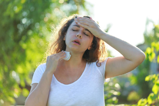 istock Young woman having hot flash and sweating in a warm summer day 1557892422