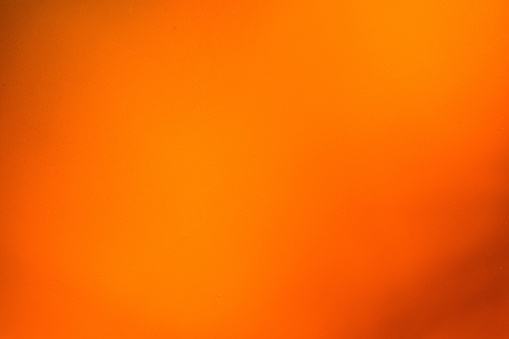 Abstract blurred shiny orange wall texture background