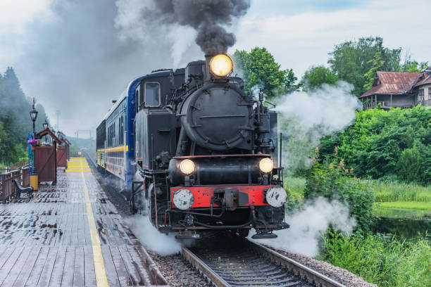 istock Retro steam train approaches to the platform. 1557943577