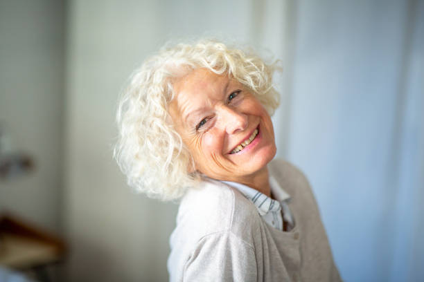 istock Close up happy older woman looking at camera 1557949764