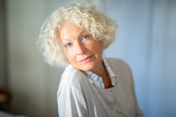 istock Close up attractive older woman looking at camera 1557950100