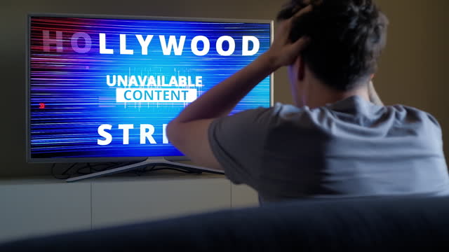 Upset viewer emotionally reacts on Hollywood Strike news on TV screen