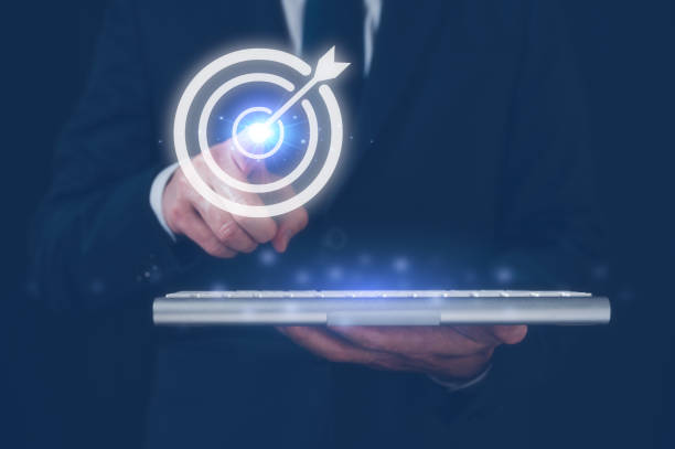 istock Hand pointing target board for creative and set up business objective target and success and business goals in Concept of business strategy and future sustainable business finance action plan 1557968286