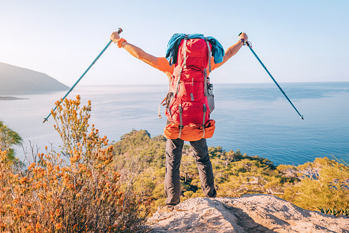 A contented man stands proudly at a viewpoint on the Lycian Way trail, showcasing his hiking gear and love for exploration. Travel and solo adventure in Turkey