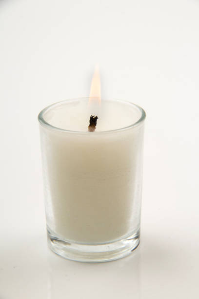 istock Glass Candle and metal lid on white background 1557972576