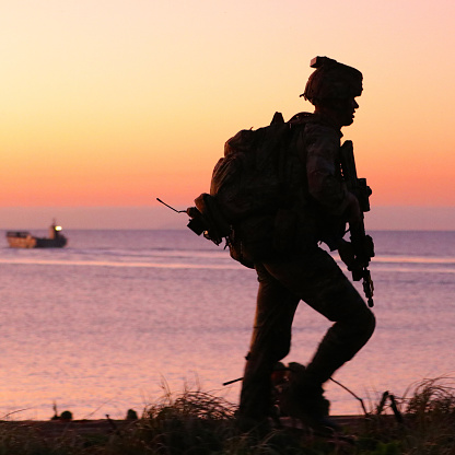 A Soldier from the Australian Army patrols the beach during dawn attack Cowley Beach, QLD during ex Talisman Sabre 2021 as apart of the biannual military exercise with the USA and other allies