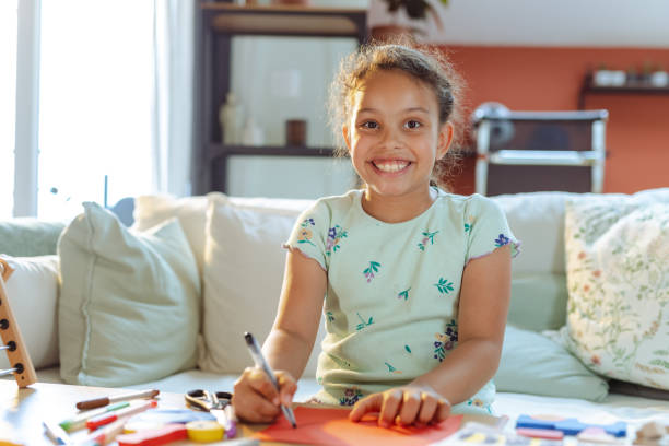 istock Cheerful girl drawing 1557987766
