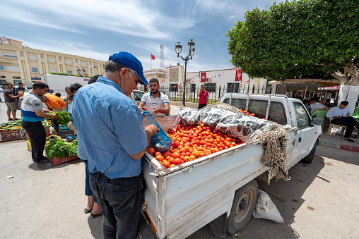 El Jem, Tunisia - June 17, 2019: Local Street Market In El Jem, Tunisia. People are selling vegetables